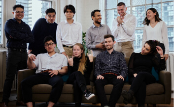 The Nimbus team - a group of 10 professionally dressed men and women make funny poses for the camera
